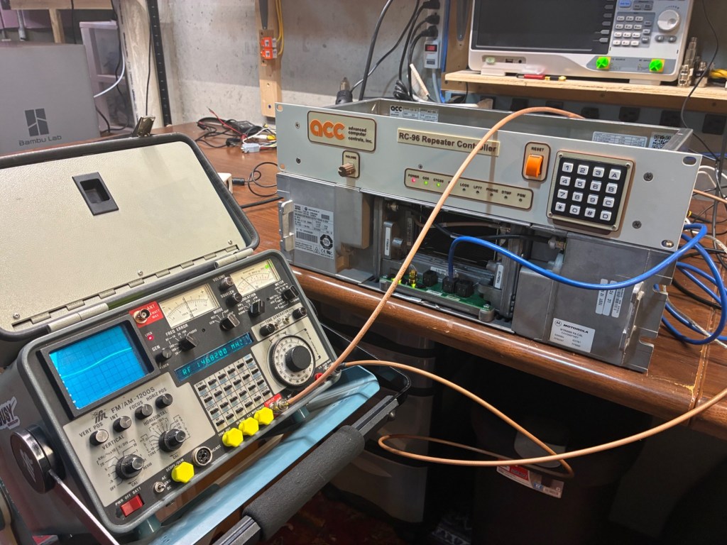 The Last RC-96 sitting on top of an MTR2000 repeater (shown rear-facing-front) with a service monitor in the foreground.