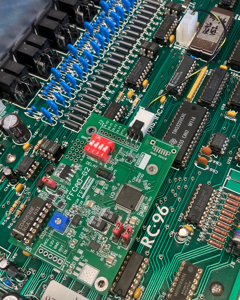 Image of the delay board installed on the RC-96 with the COS cable connecting to the RC-96.